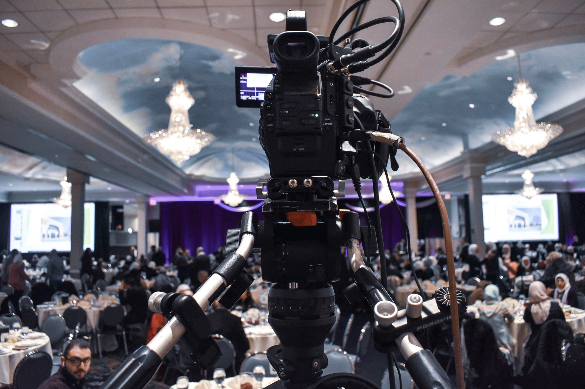 Professional video camera recording event in ballroom